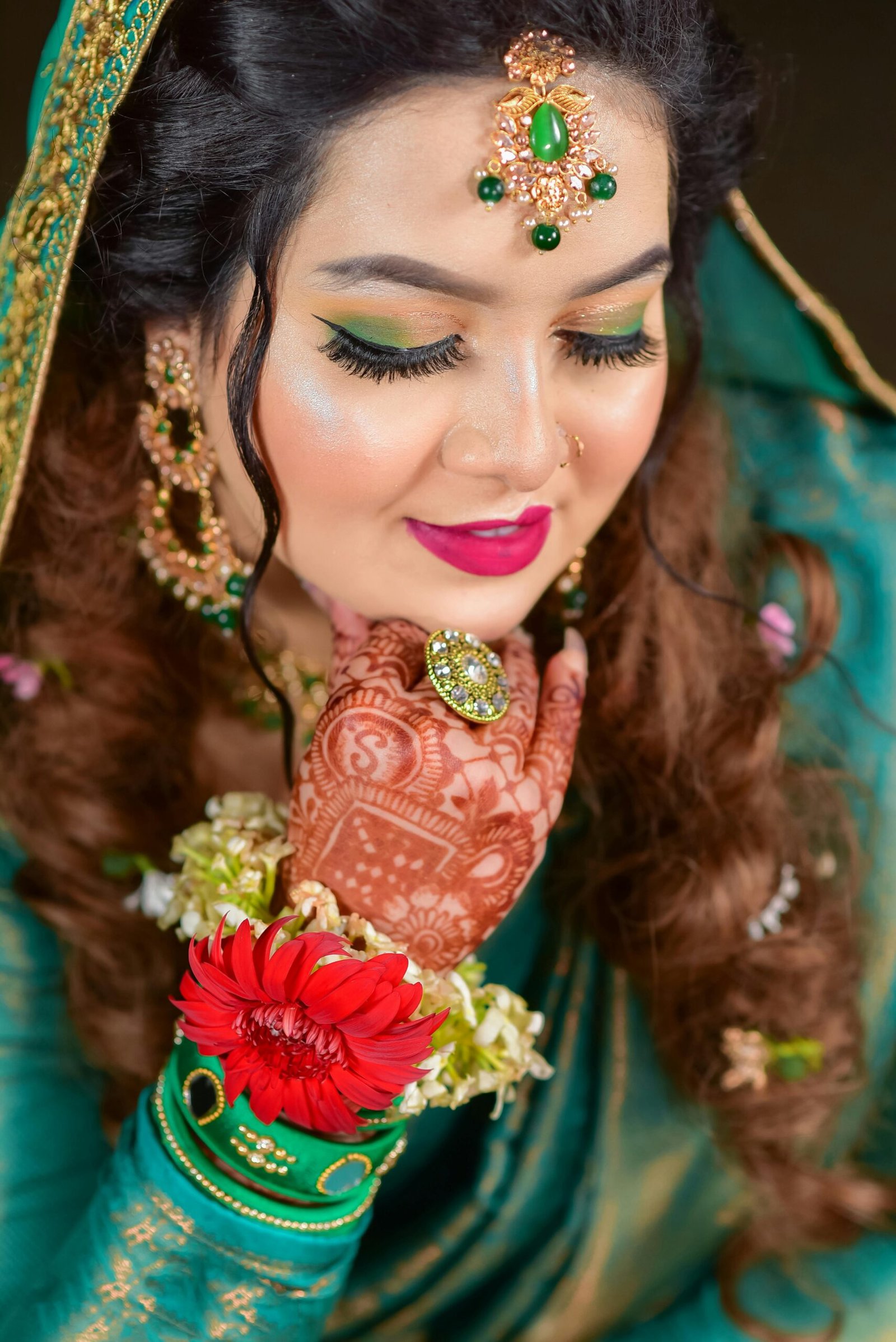 Close-up of a South Asian bride with intricate henna and traditional jewelry, exuding elegance and cultural richness.